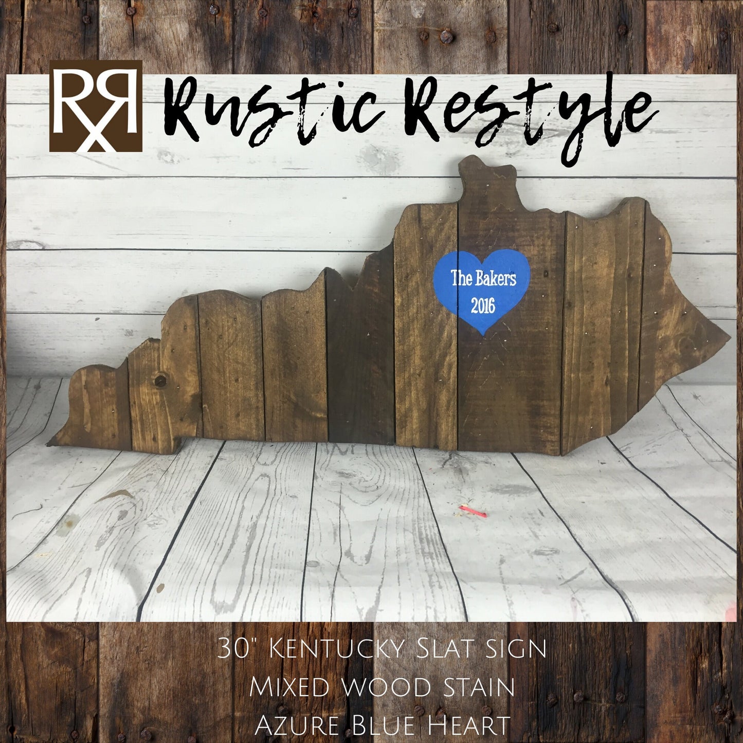 Kentucky-shaped wood sign leaning up against a faux white wood wall. Vertical wood slats with nail holes showing. A Azure blue heart is painted near the upper middle with the name The Bakers and year 2016 painted on it.