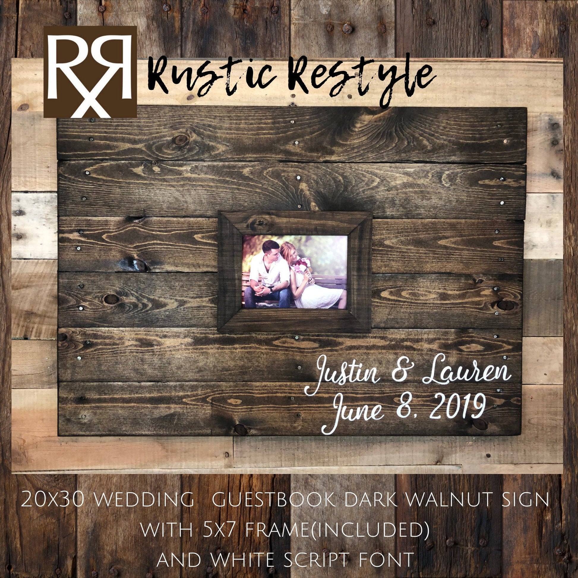 There is a rectangular wooden guestbook sign hung on a lighter wood wall. In the center, there is an engagement photo in a matching wood frame. Painted in the lower right corner is Justin and Lauren in white script font. Along with the date 6.8.19.