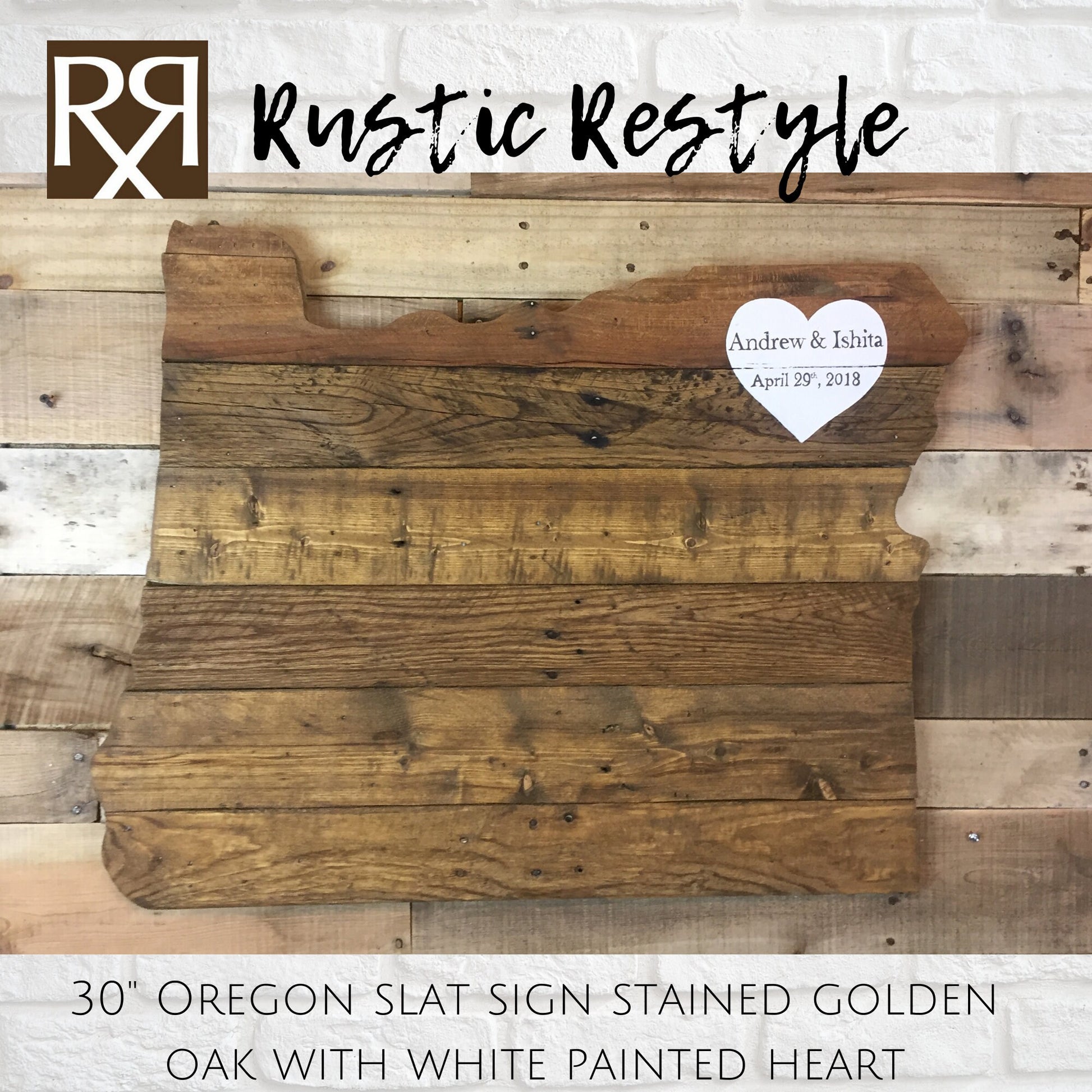 wood sign shaped like Oregon, old dark worn boards hanging on a rustic wood pallet wall with a  White heart painted in the upper right corner with personalization Andrew & Ishita