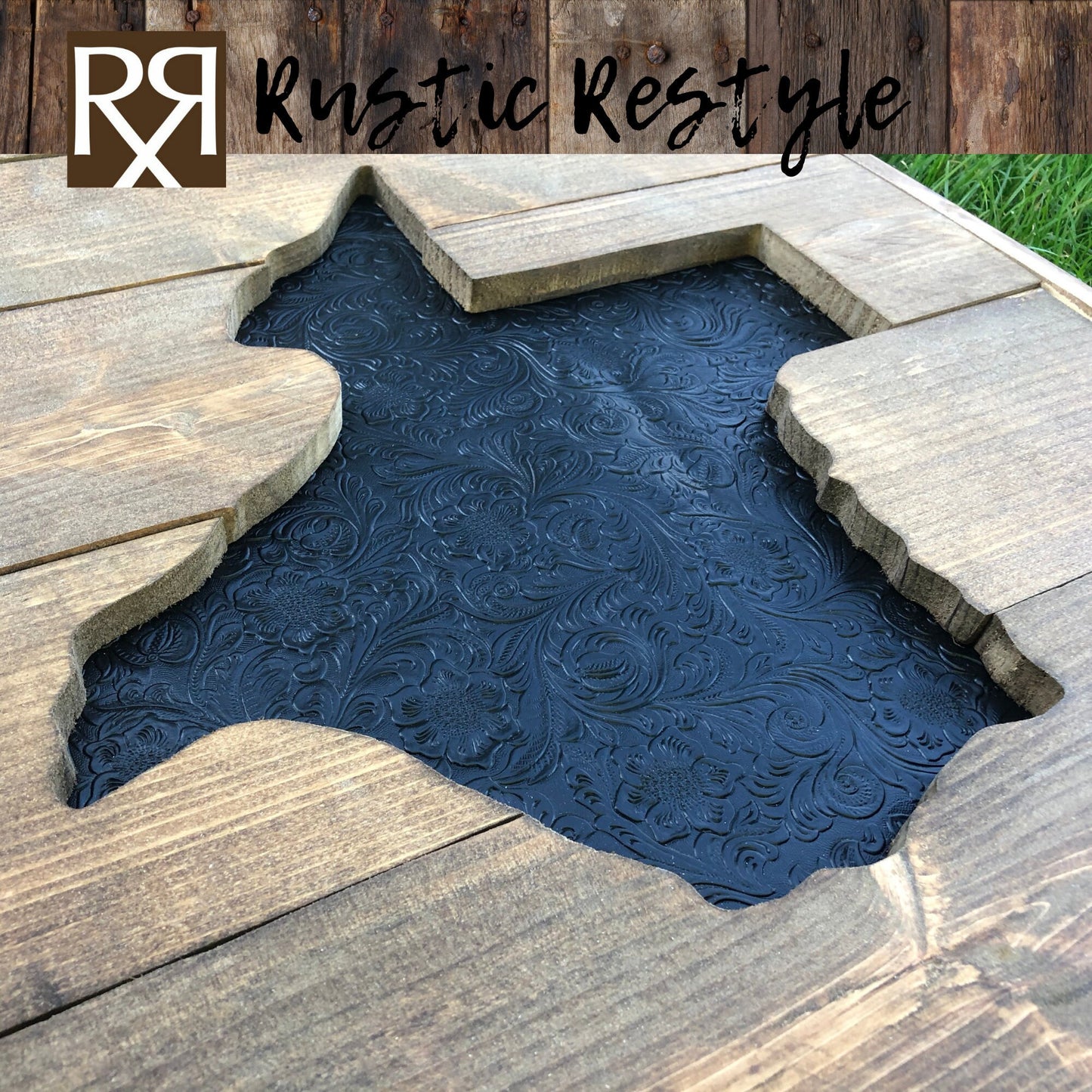 Large square wood sign with a texas shape cut out of the middle laying flat in the grass at an angle. The center Texas is recessed in and covered in faux black tooled leather.