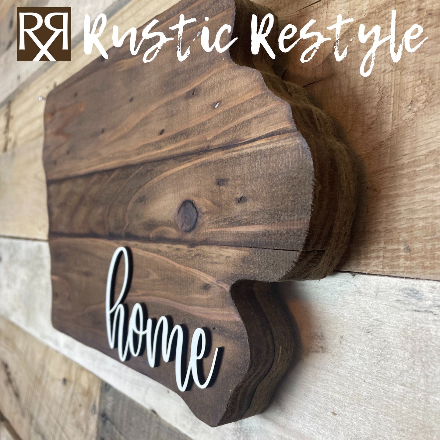 A side angle view of iowa shaped wood sign with dark planks.
Script font white word "home" in the bottom right corner. The sign is hanging on a wood pallet plank wall.