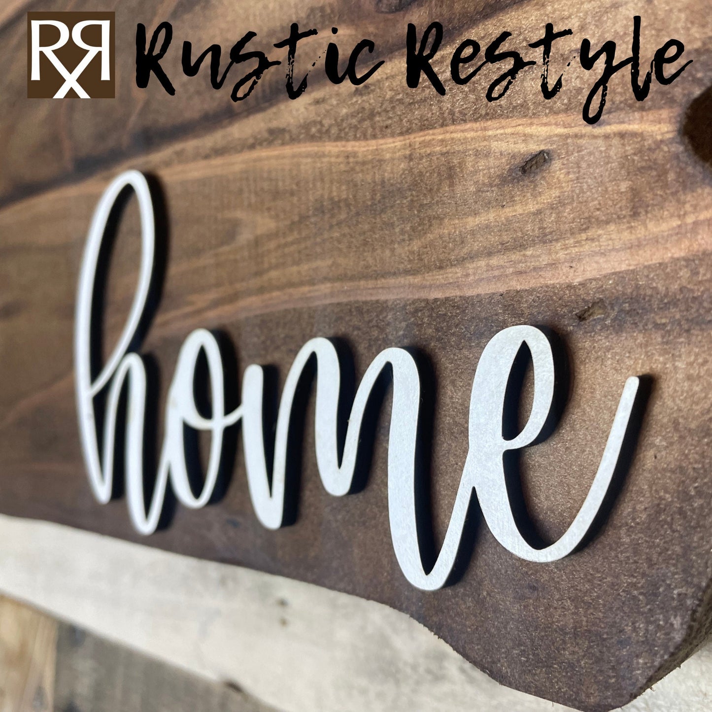 Zoomed in veiw of A side angle view of iowa shaped wood sign with dark planks.
Script font white word "home" in the bottom right corner. The sign is hanging on a wood pallet plank wall. Rustic restyle is written along the top of the photo.