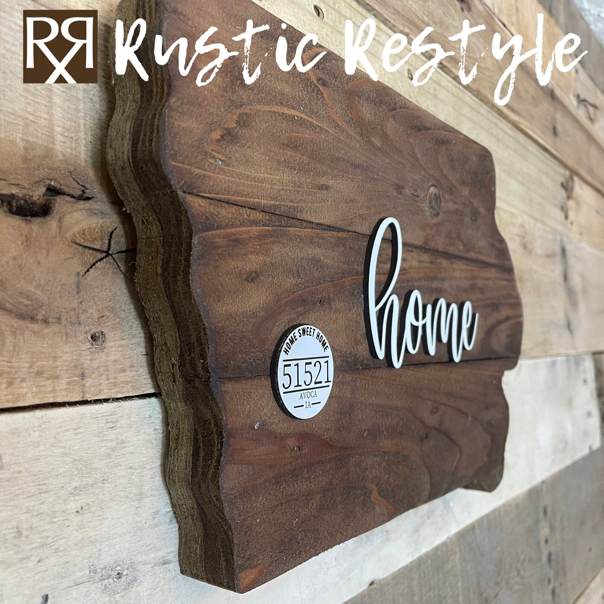 Wooden Iowa shape sign left side view on a flat table. The word home is across the middle in white. There is a small white wooden disc on the left middle with home sweet home, 51521 zip code and Avoca engraved on it.