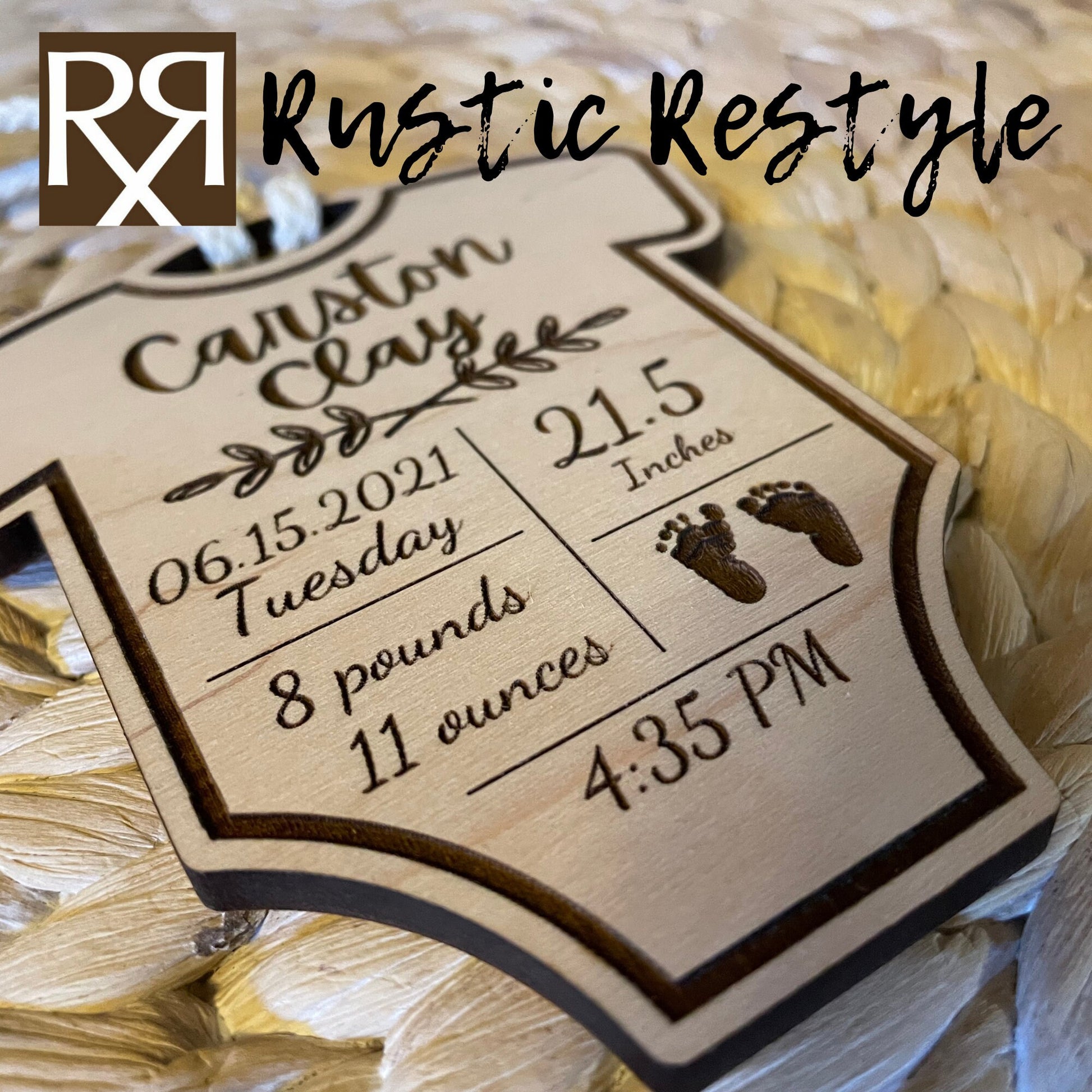 A natural wooden ornament shaped like a baby onesie and hung by a white cotton braided string. This Item is engraved with the baby's name and birth stats.