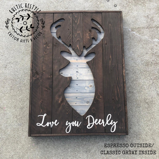 A wooden sign with a deer head silhouette cut out of the wood, displaying the text "Love you Deerly" in a rustic style.