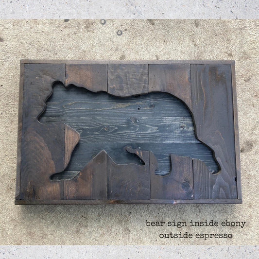 a wooden bear cut out, with the text "bear sign inside ebery outside espresso" written below it.