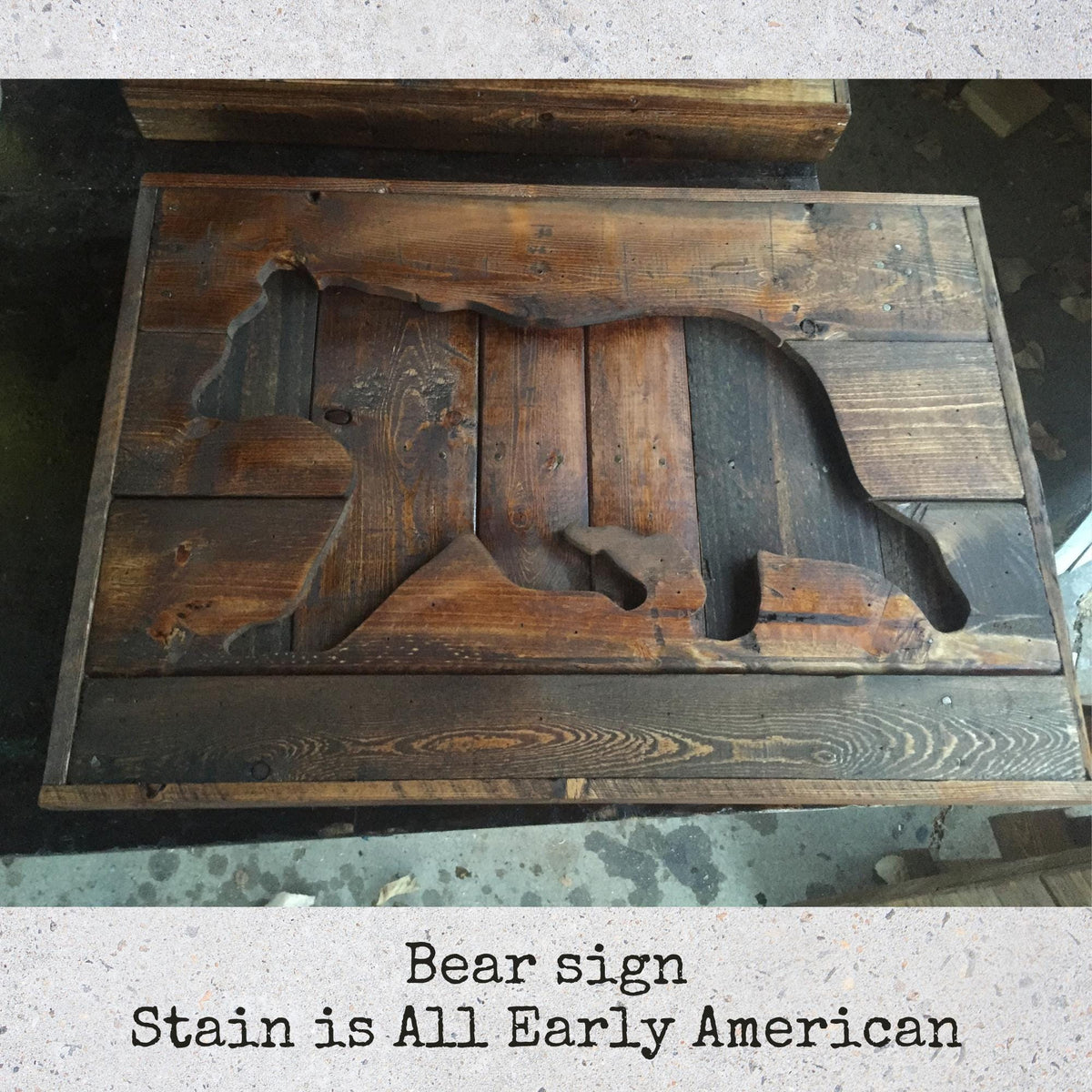a wooden bear cut out from a piece of wood, sitting on a wooden surface.