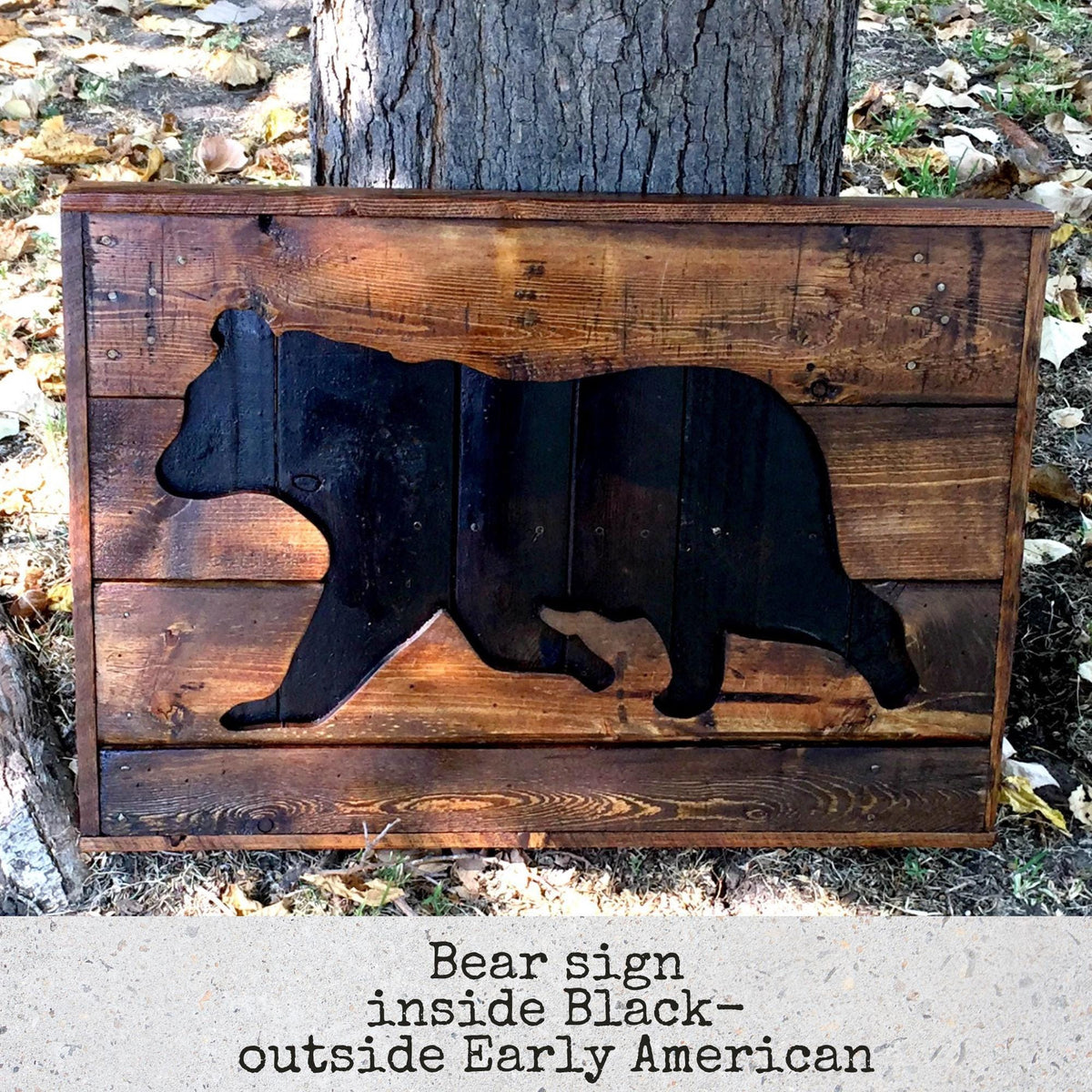 A wooden sign featuring a black silhouette of a bear, with the text "Bear sign inside Black - outside Early American" below it.