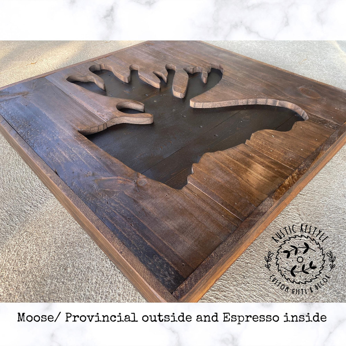 A wooden sign with a moose silhouette cut out, representing the moose/provincial outside and espresso inside.
