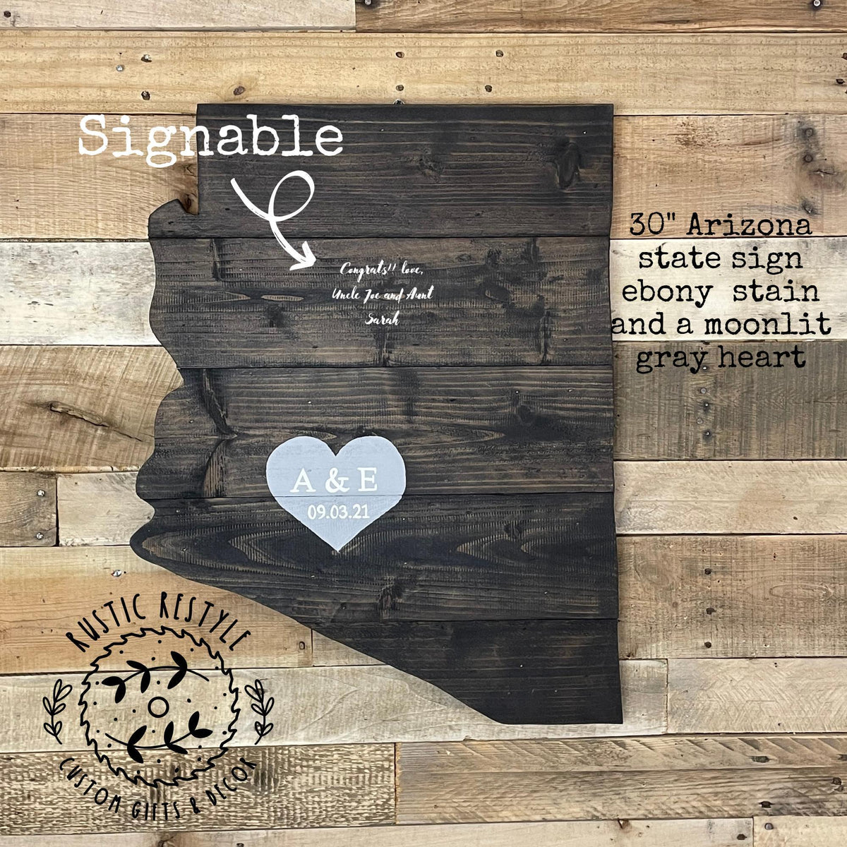 The image is a wooden sign depicting the state of Arizona, with a heart symbol and text indicating it is a 30 inch Arizona state sign with an Ebony stain and a moonlit gray heart.