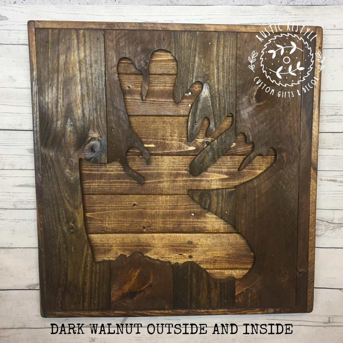 a wooden cutout of a moose, with the text "Dark Walnut Outside and Inside" below it.