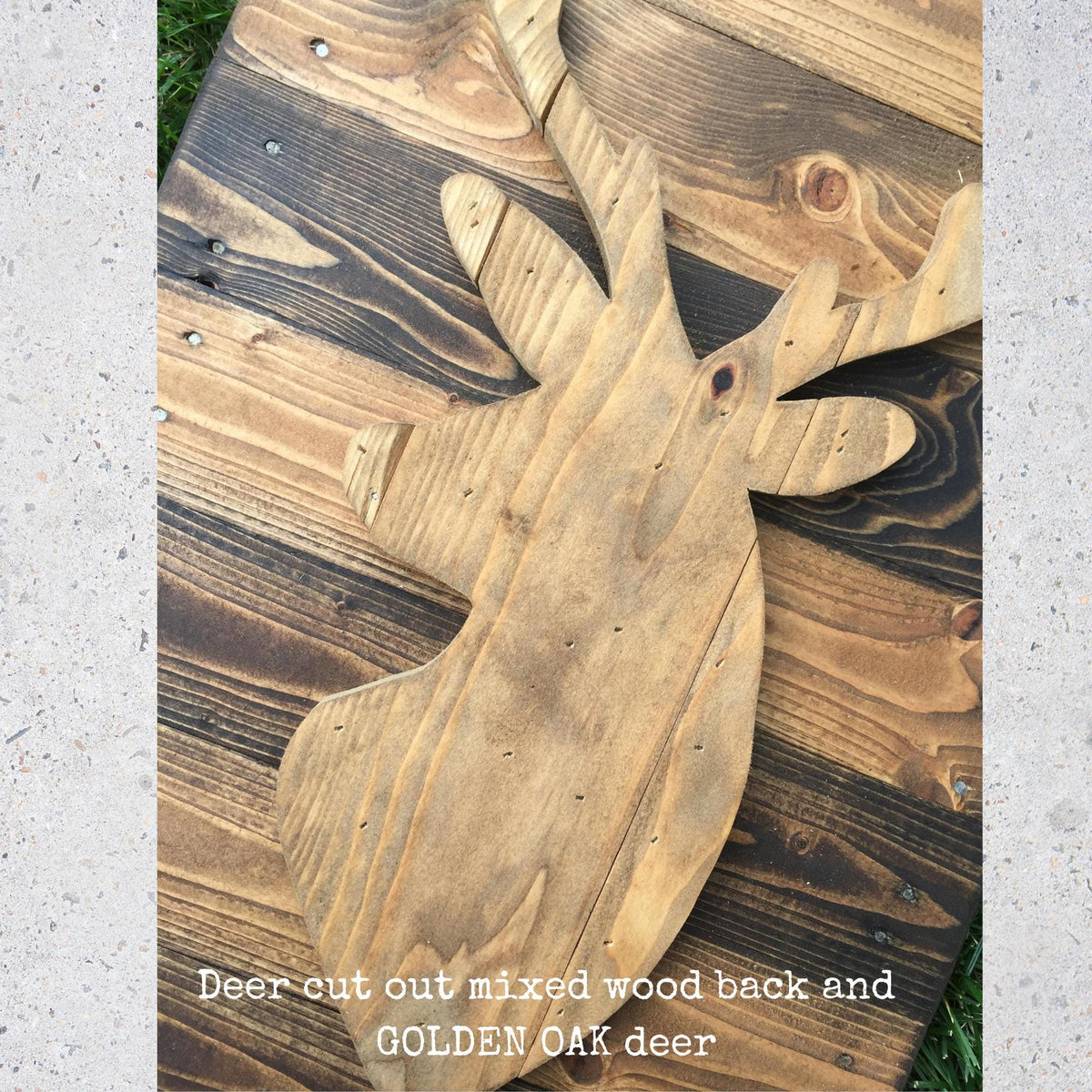 a wooden deer head with a mix of wood back and a golden oak finish, sitting on a wooden surface.