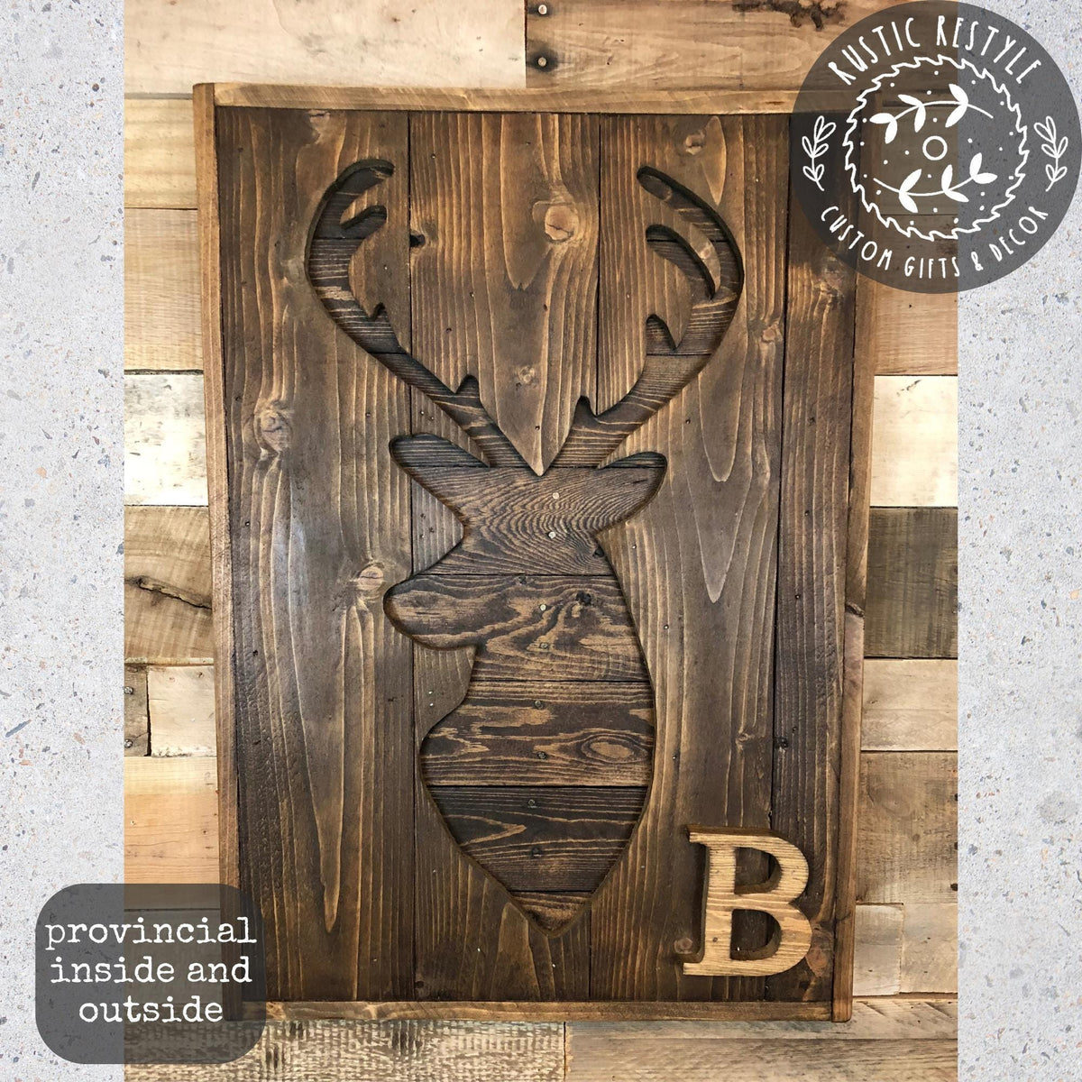 a wooden deer head with a letter "B" carved into it, mounted on a wooden wall.