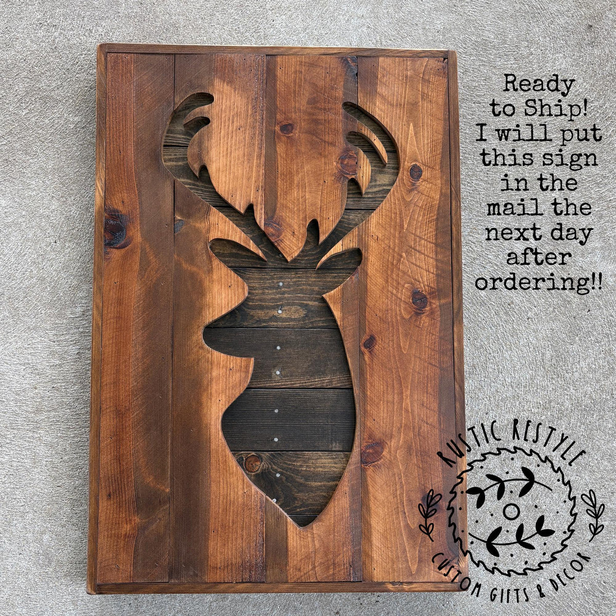 a wooden sign with a deer head cutout, likely intended as a decorative piece or wall hanging.