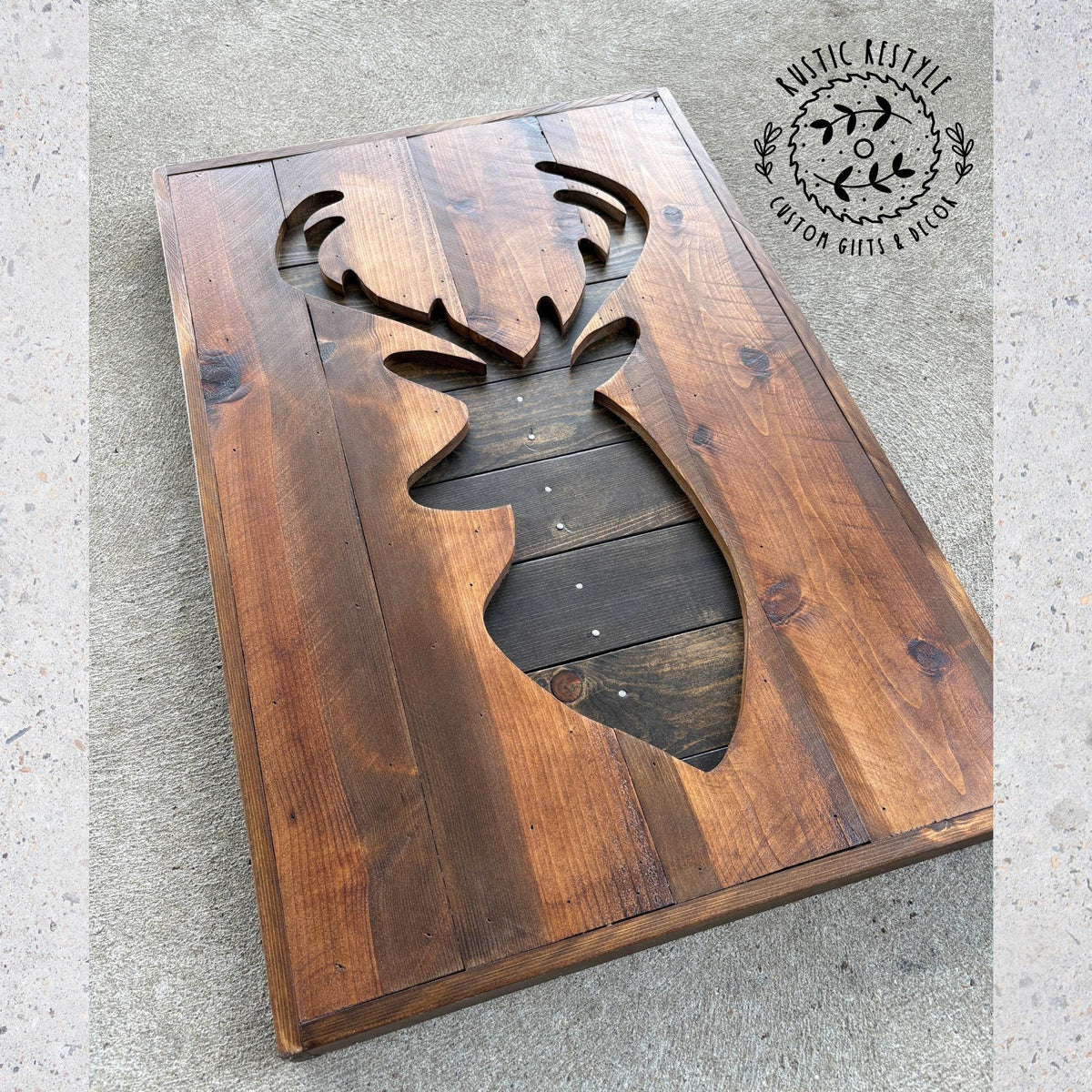 a wooden board with a cutout in the shape of a deer head, which appears to be a decorative piece.