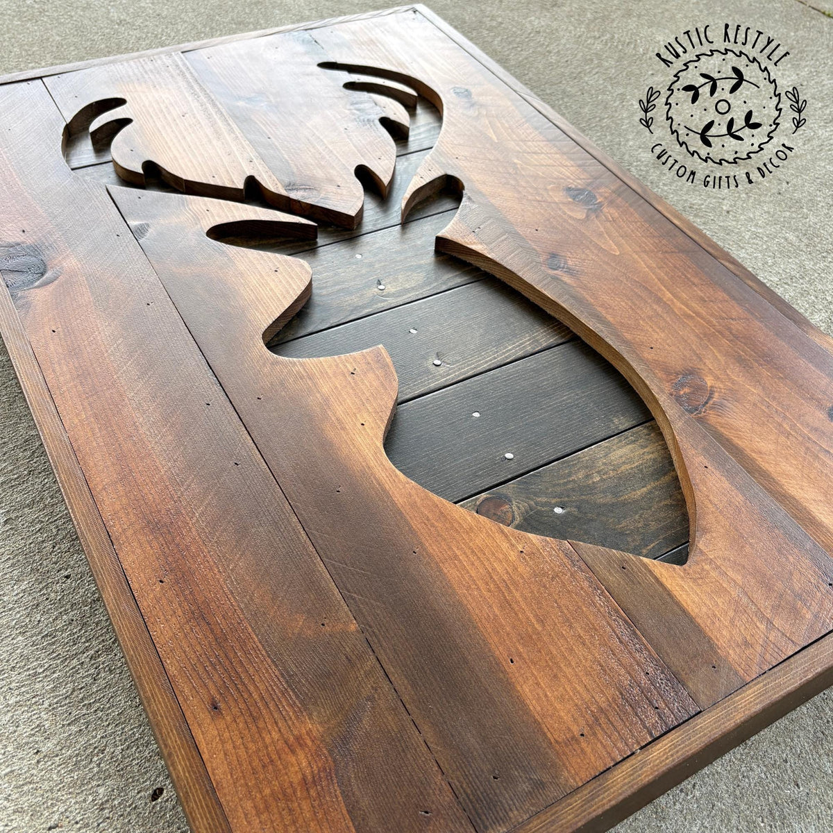 a wooden coffee table with a carved deer head design on it.